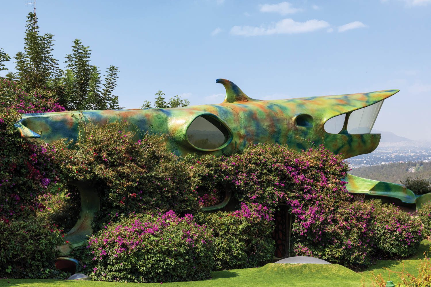 Flowers cascade down the exterior of "the shark," which features a single fin on top. 