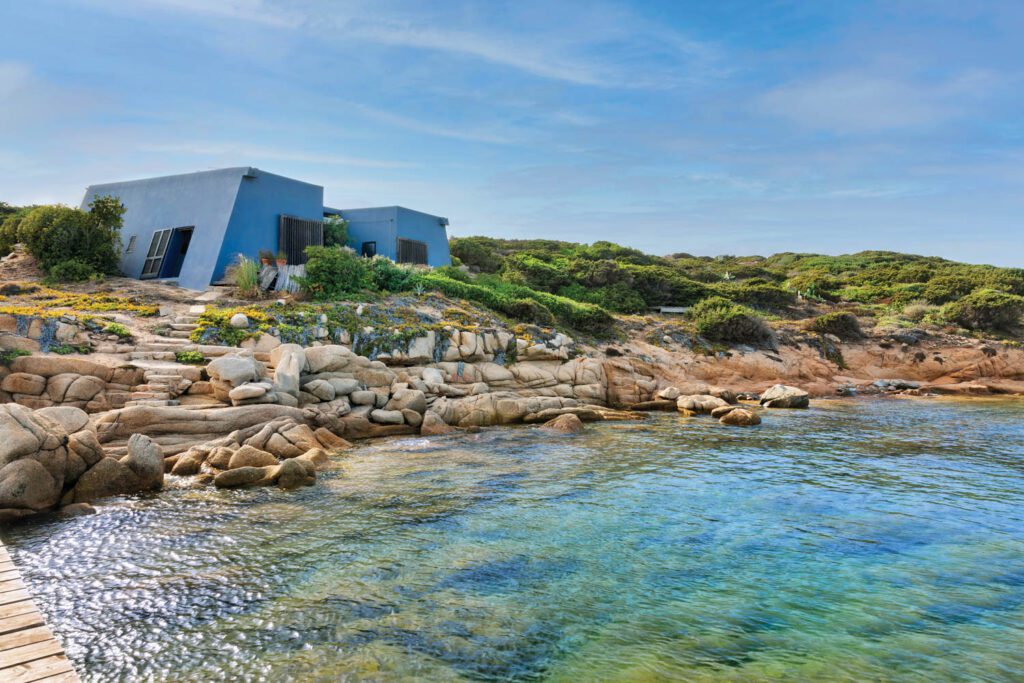 Resembling a brutalist tent, the reinforced-concrete structure perched on the rocky shoreline.