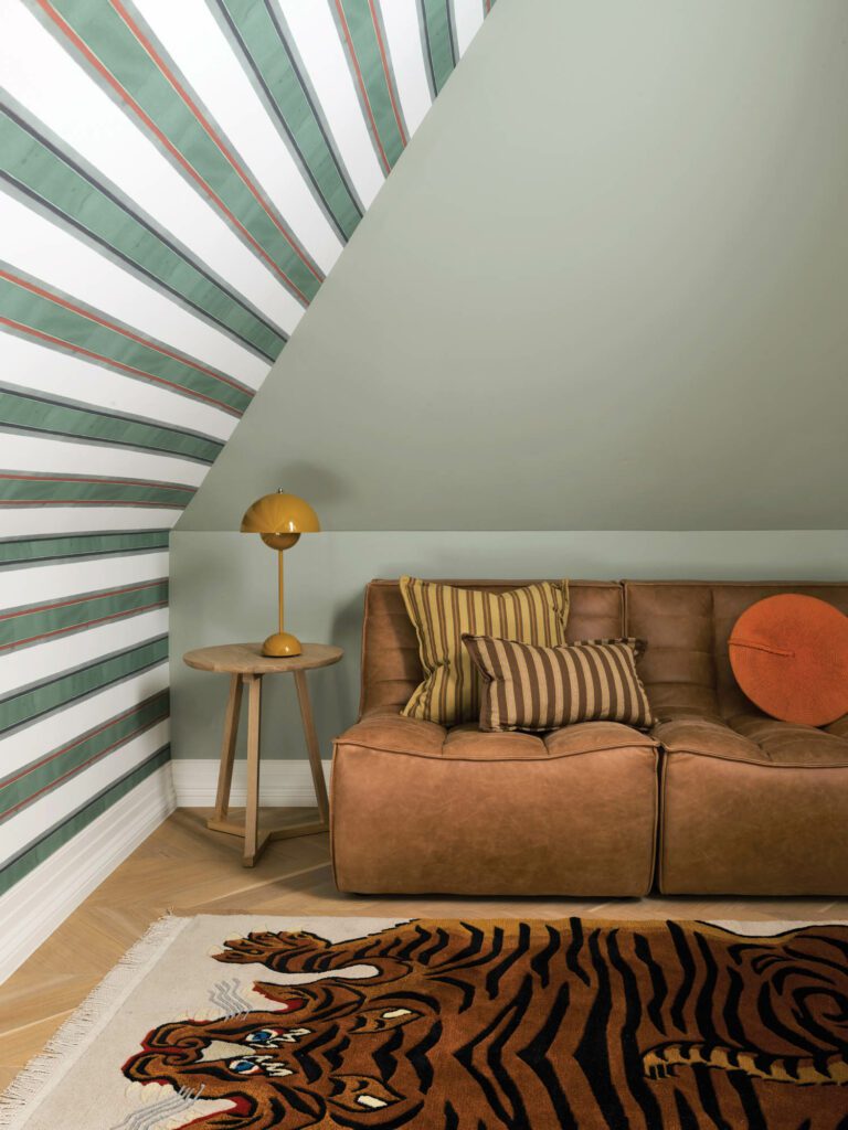 Sibella Court’s Franklin wallpaper animates a small sitting area, dubbed the cubby, off son Peter’s bedroom, illuminated by a Verner Panton Flowerpot lamp.