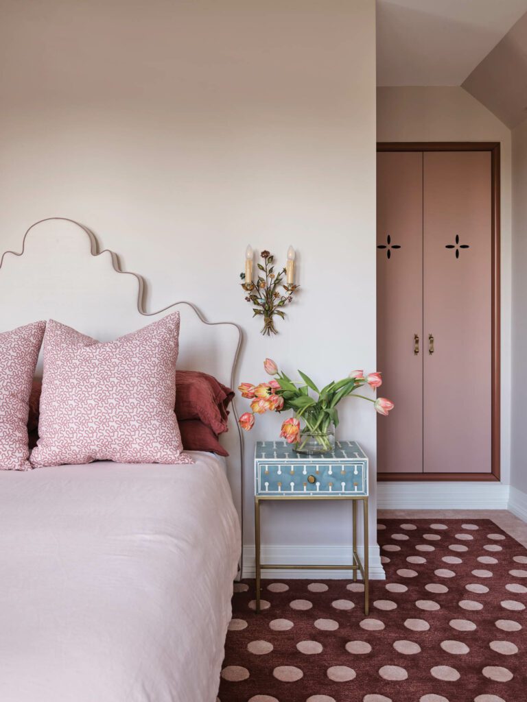 A deft layering of shapes, colors, and patterns creates sophistication in Annabelle’s bedroom, with a custom headboard and carpet.