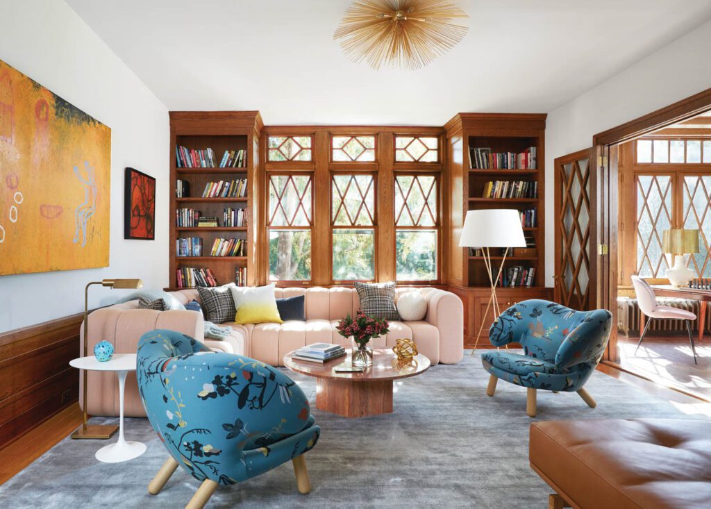 A pair of Finn Juhl chairs and a Bob sectional designed by Thomas Bernstrand and Stefan Borselius furnish the living room’s seating vignette; the area rug, like most of the floor coverings throughout, is from Aronson’s.