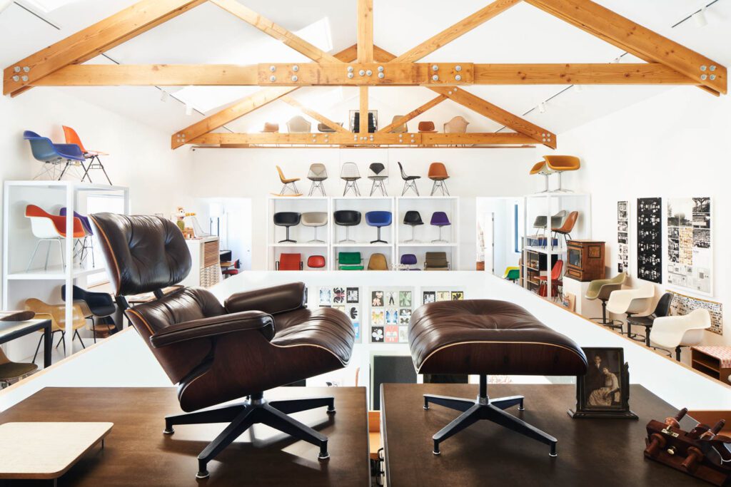 Chairs by Ray and Charles Eames in a room with lofted ceilings.