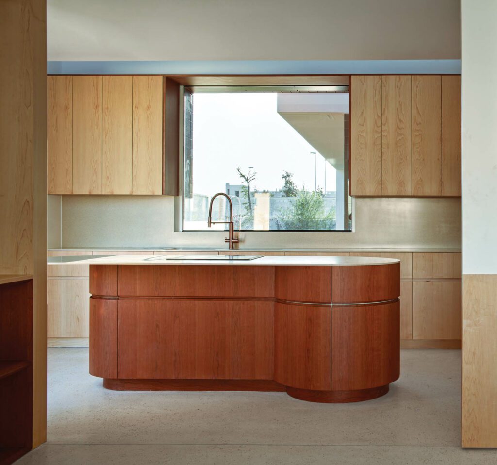 a kitchen island in front of a large window