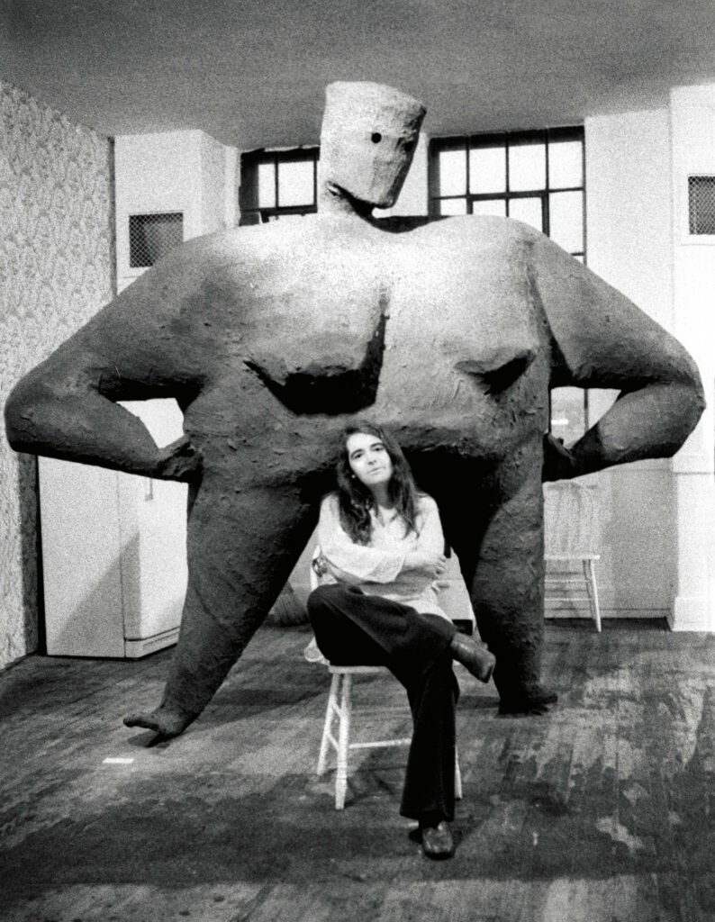 Kate Millet (1934-2017) in front of her 1977 sculpture, Kitchen Lady.