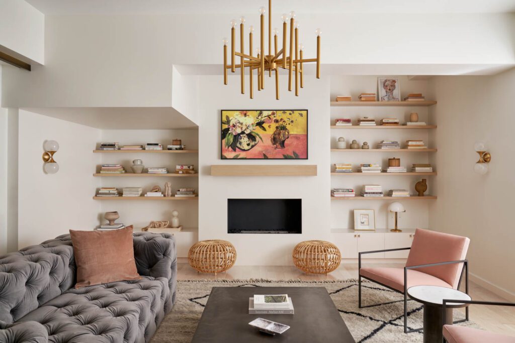 a modern living room with pink accents and a grey sofa