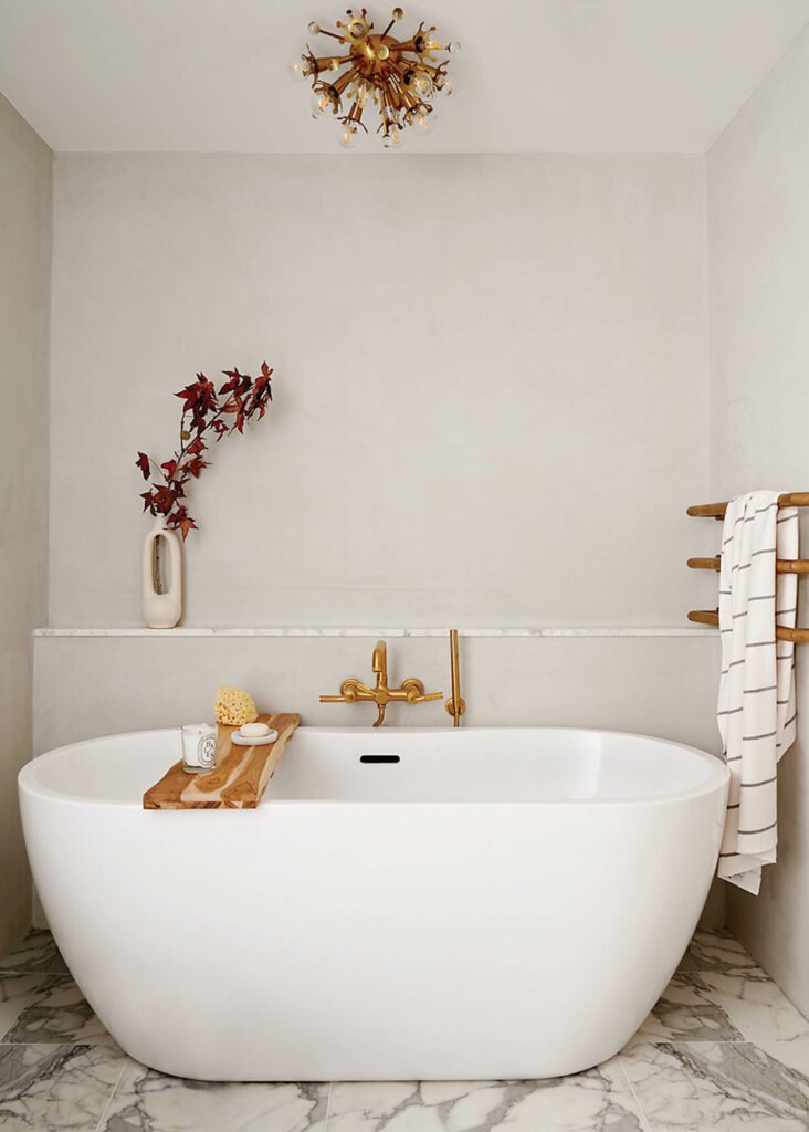 a large bathtub in an off white bathroom