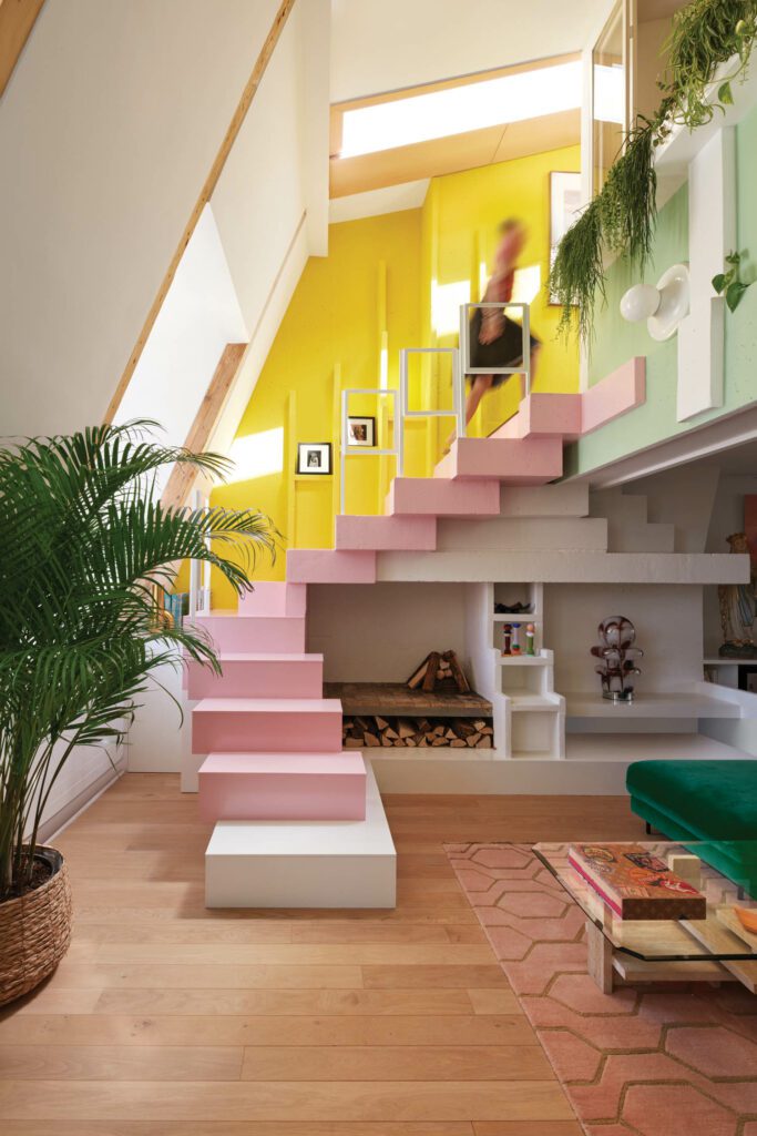 a pink staircase flanked by yellow walls