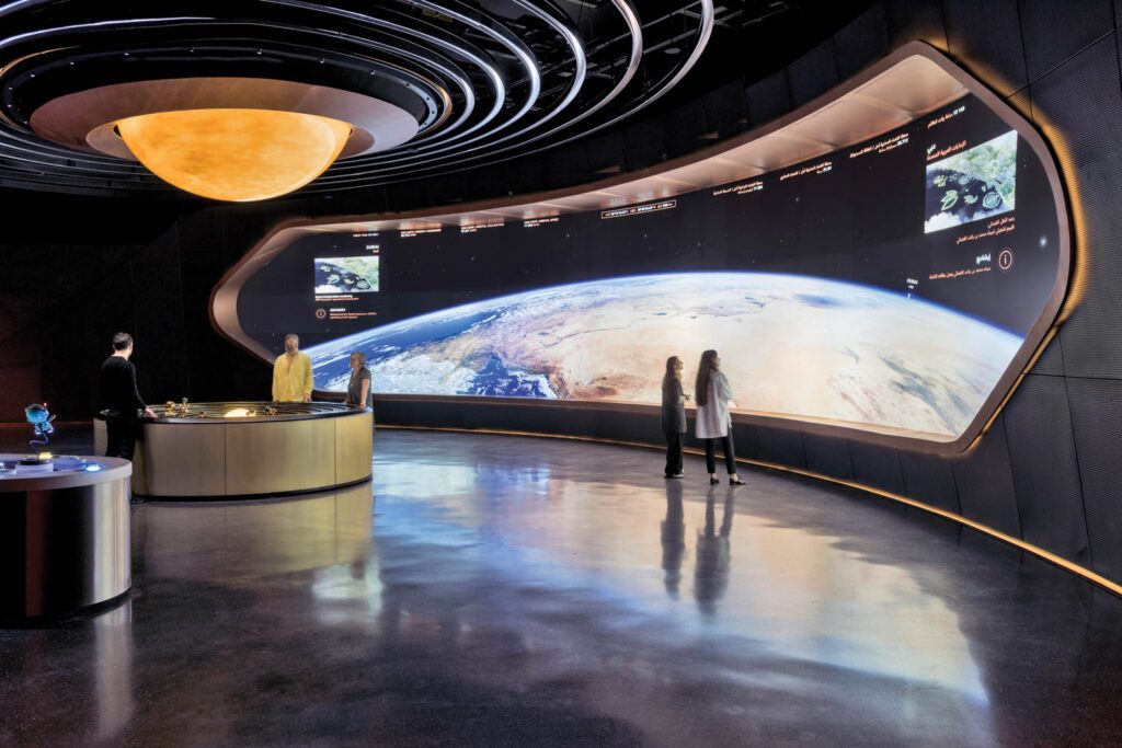 Two guests gaze at an image of Earth at the Museum of the Future in Dubai