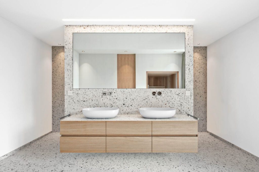 a bathroom with floating double vanity and marble throughout