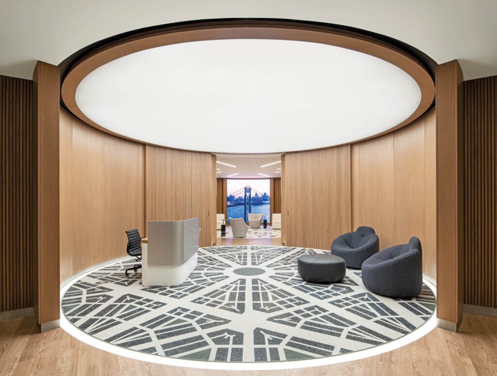 In reception, more Paulin chairs and the custom desk stand on terrazzo laid out in Detroit’s city grid.