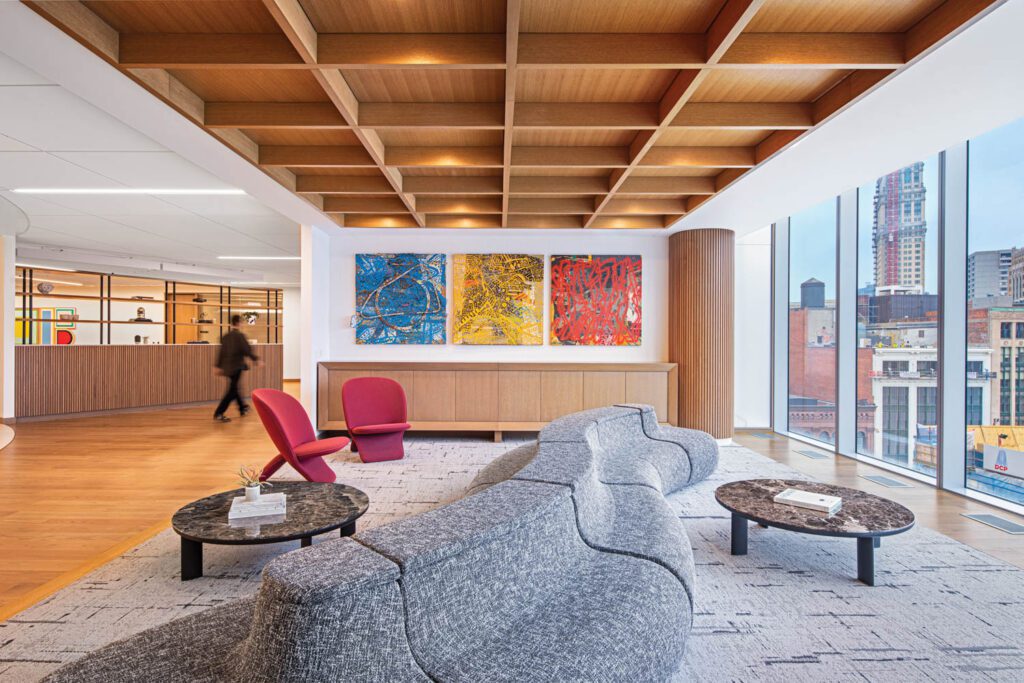 A triptych by late local painter Charles McGee over­looks the 18-foot-long modular Isla sofa by Koz Susani Design, Khodi Feiz’s Niloo chairs, and Saragosse tables by Alain Gilles in a lounge outside the boardroom.