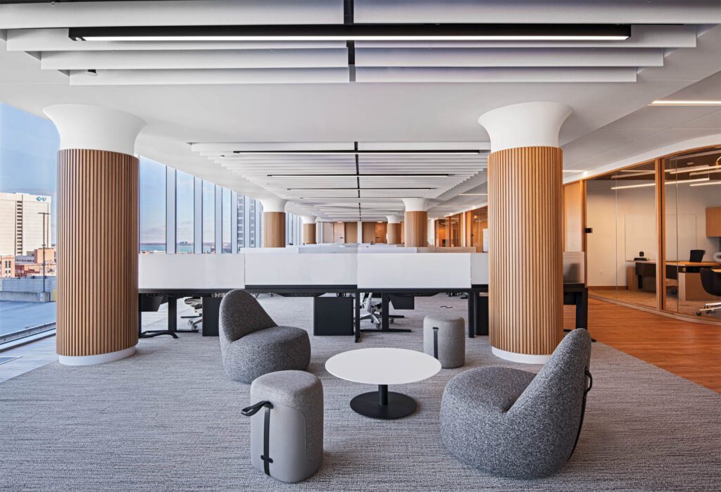 A breakout space in the open office area features Mitt chairs by Claudia & Harry Washington, Leo Su’s Tour ottomans, and Jephson Robb’s Quiet table on carpet tile.