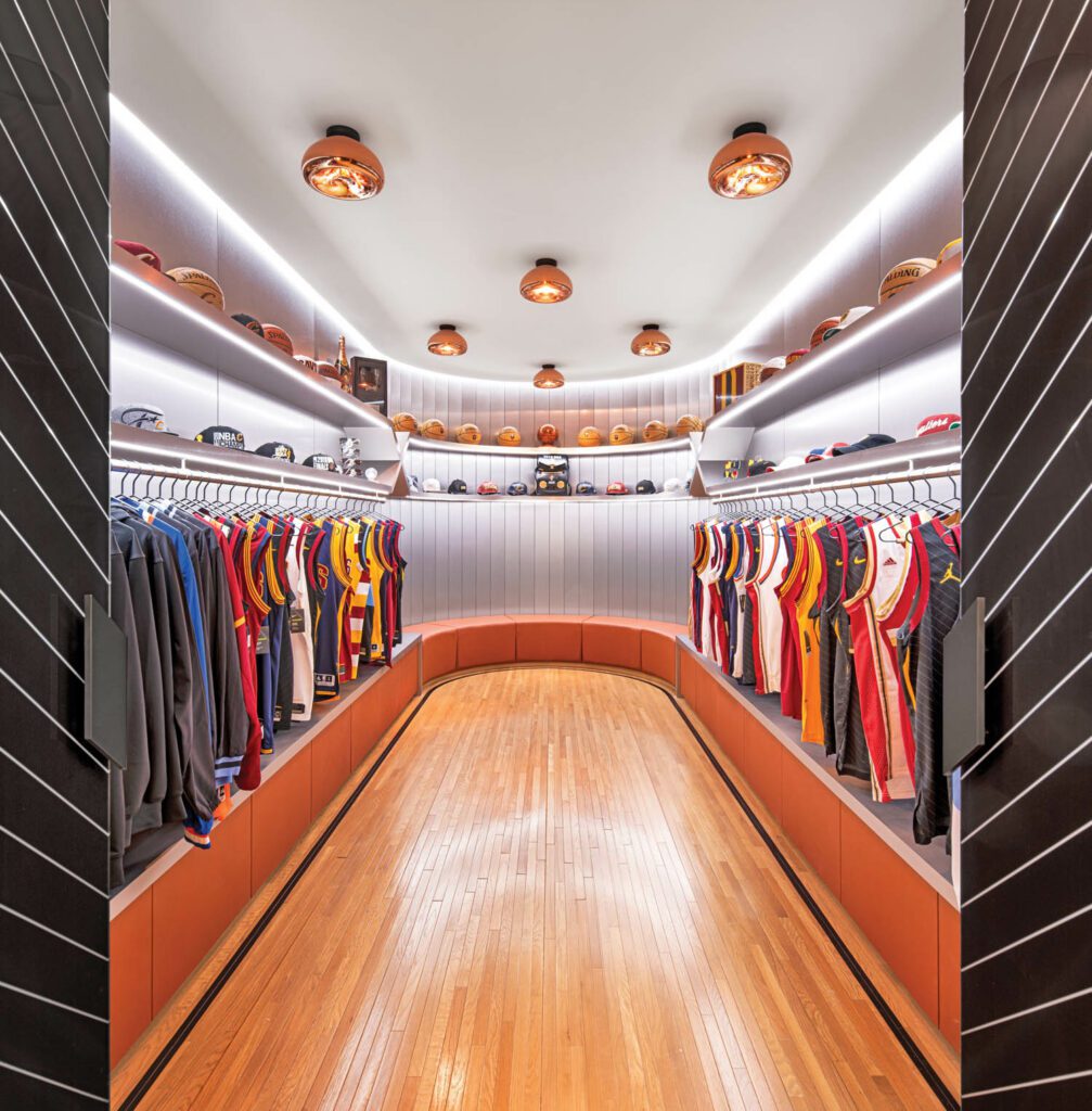 Tom Dixon’s Void surface-mount fixtures and recessed linear LEDs illuminate the walk-in closet filled with Cavaliers gear.