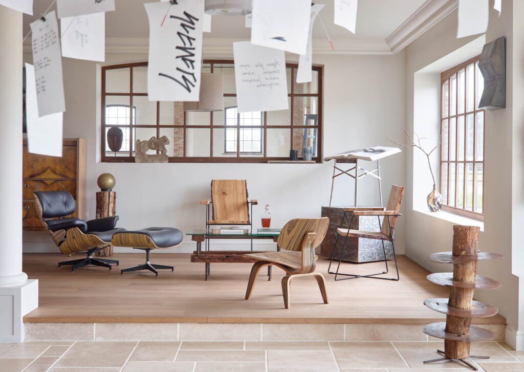 Seating in the den includes custom live-edge oak chairs and a vintage Eames lounge chair and ottoman.