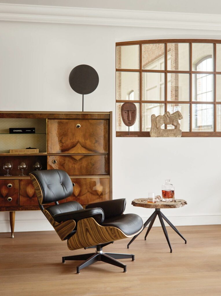 A vintage stone horse sculpture and 19th-century Senufo mask decorate the den.