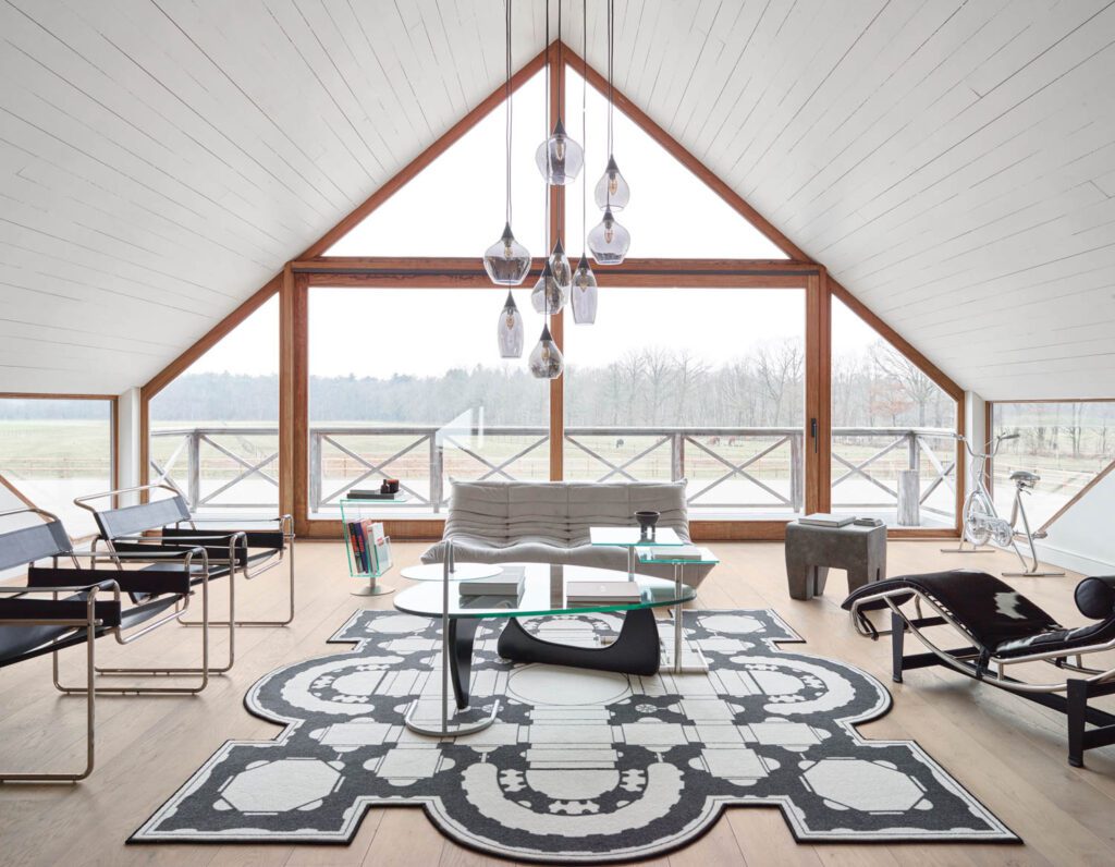 Marcel Breuer chairs, a Michel Ducaroy sofa, and a Le Corbusier and Charlotte Perriand chaise circle an Isamu Noguchi coffee table—all vintage—in the sitting room.