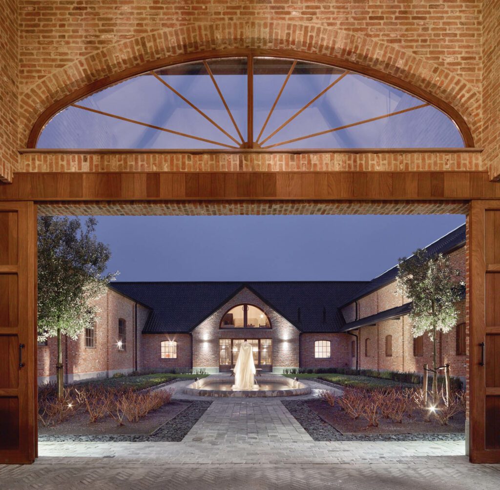 The newly landscaped private courtyard between the stable and the residence centers on an existing fountain.