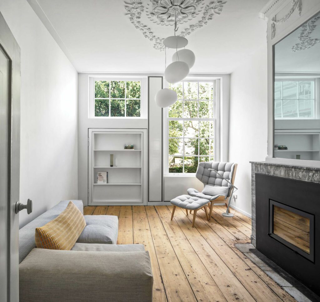 a reading nook in an Amsterdam home with sofa and fireplace