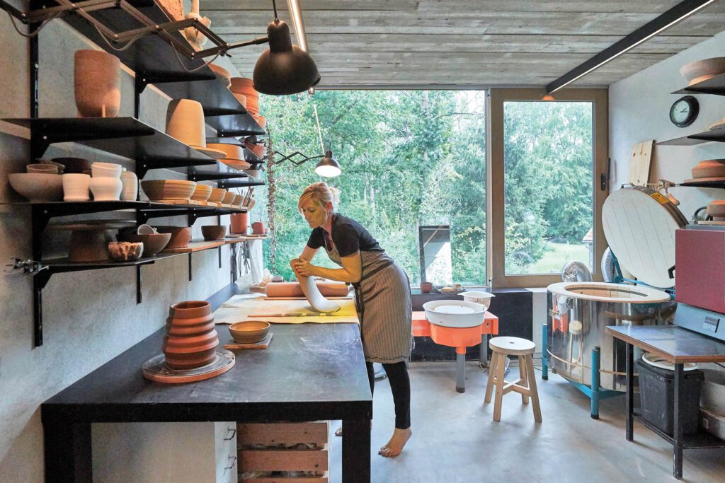 Gabriels works a clay slab in her studio.