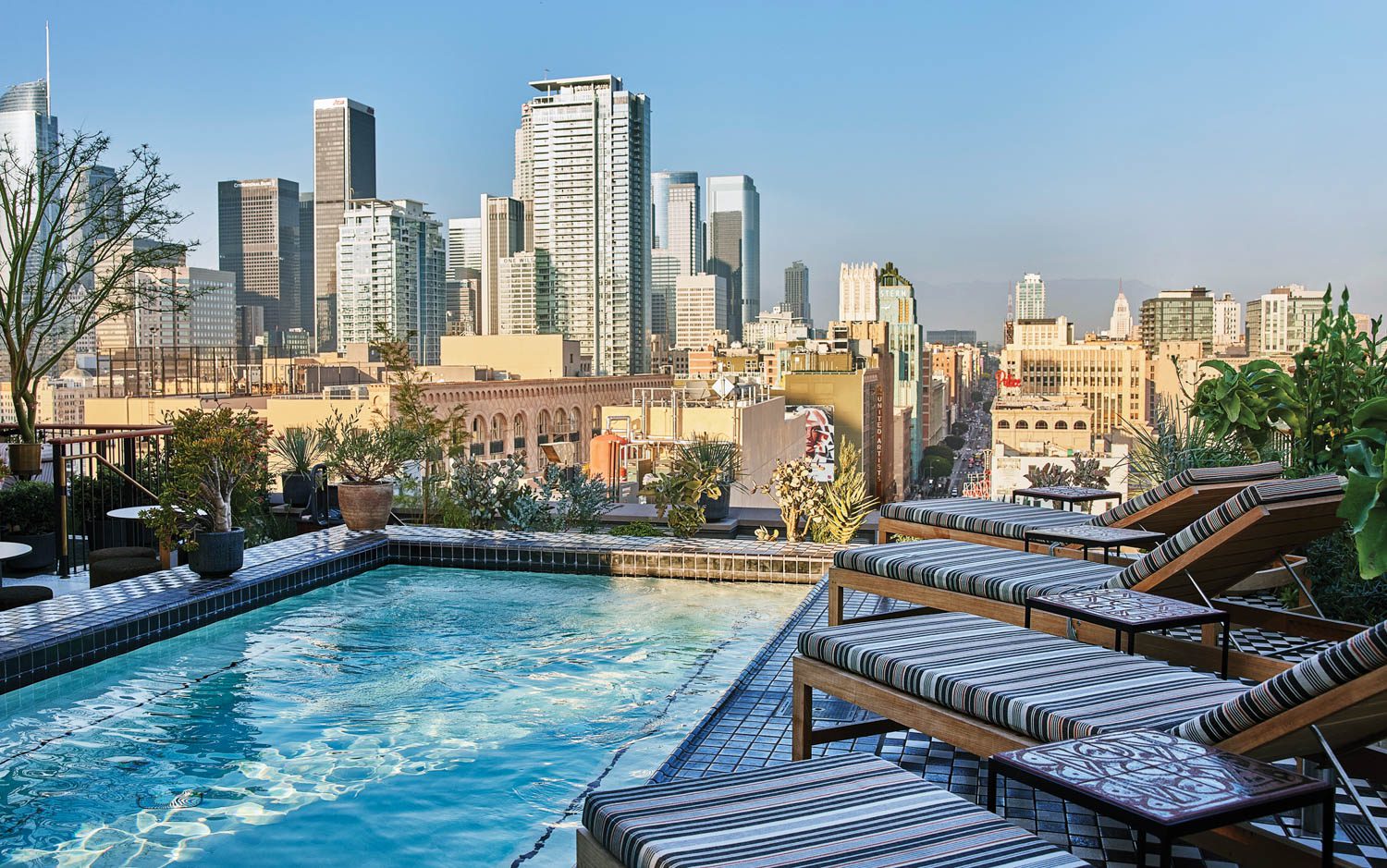 Lounging poolside on teak chaise longues is one of several rooftop options.