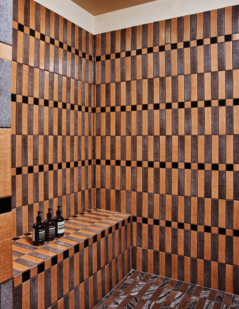 The bathroom in the Proper Pool suite is clad in custom ceramic and marble tiles.