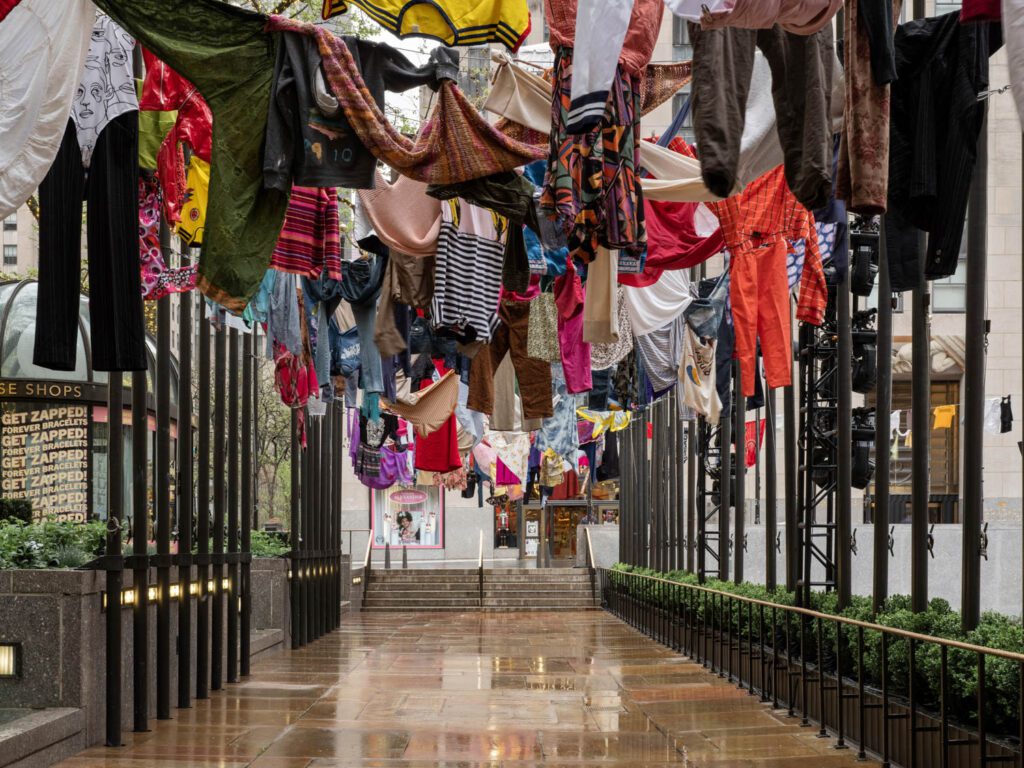 Camil’s installation of clothes exchanged with Mexico City residents claim the 193 poles that normally raise flags of United Nations countries at the plaza