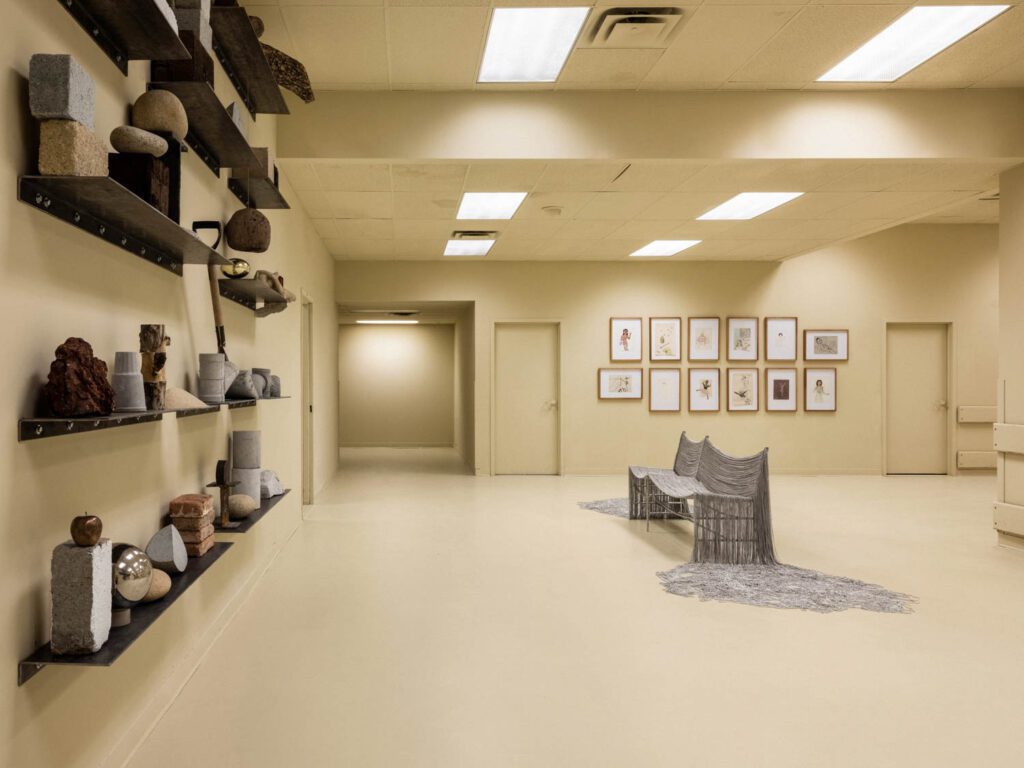 Escobar’s iron and nickel-finished ball chain chair, Creek Bench, claims a back room, its elongated metallic chains crawling across the off-white floor