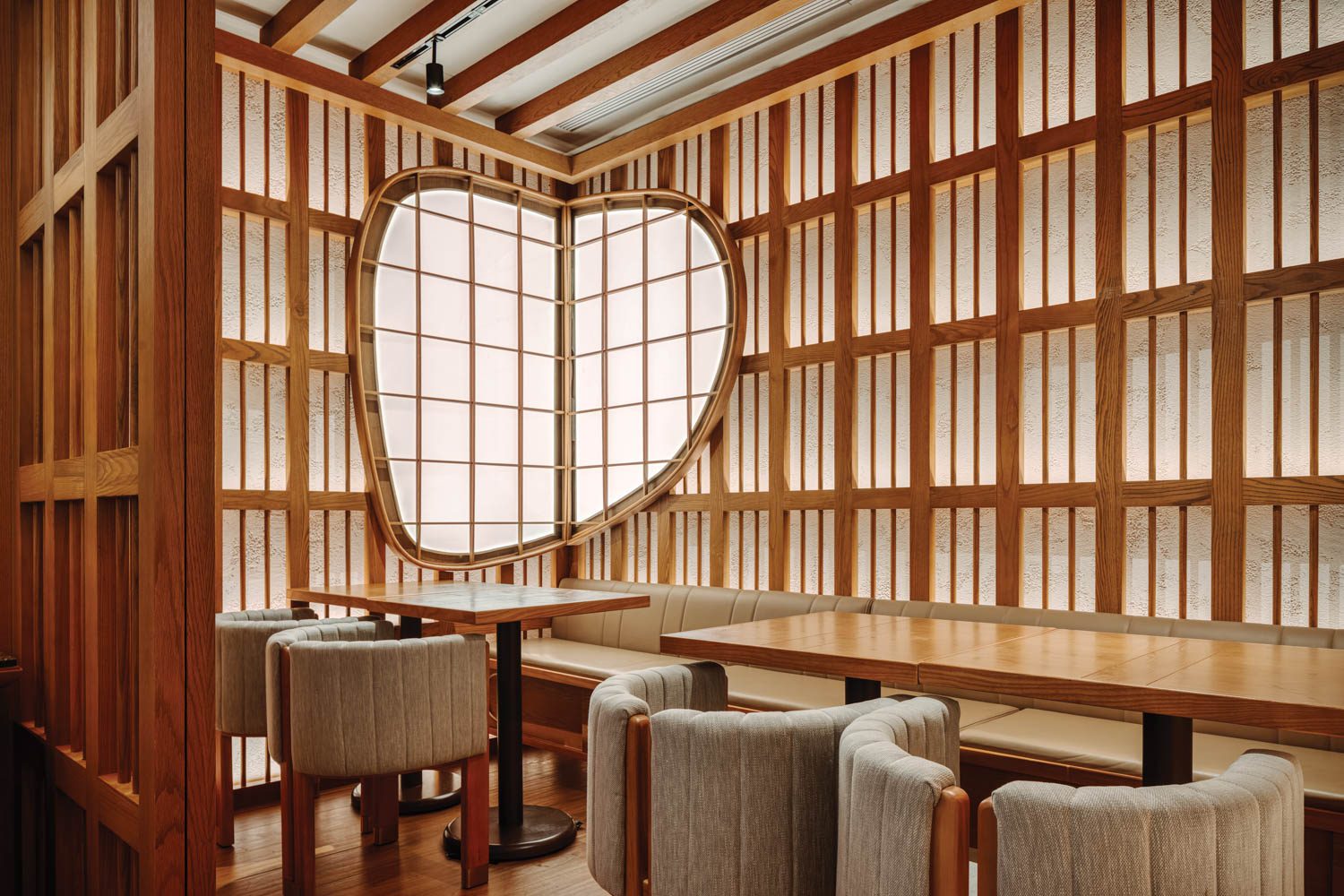 paneled walls with an orb shaped window at Takano Ramen in Hong Kong