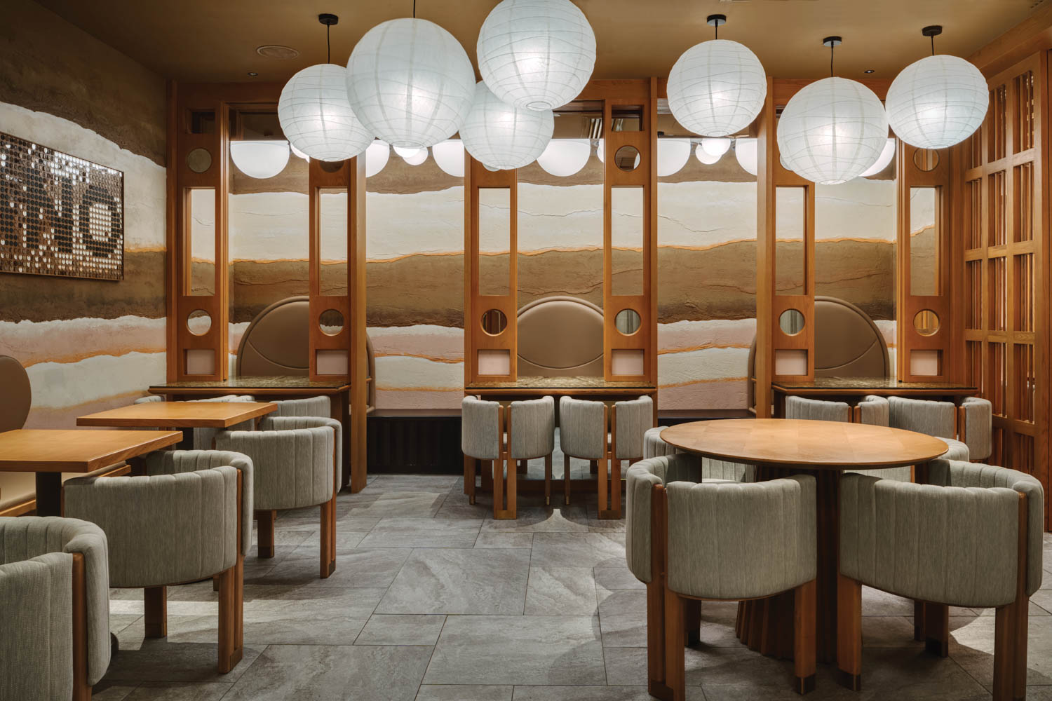 large white lanterns hang above dining tables at Takano Ramen in Hong Kong