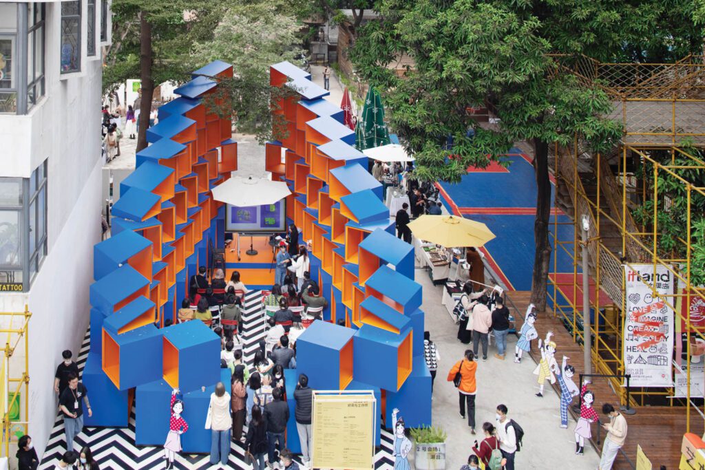 On the site of a former elementary school, Patch-City, which has been up since January, utilizes isosceles trapezoid building structures to create a space that addresses the disappearing of the traditional marketplace cultures.