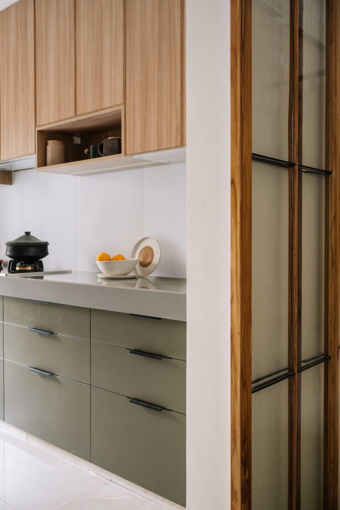 Cabinets by Kitchen Artisan hang above an engineered gray marble counter in the kitchen.