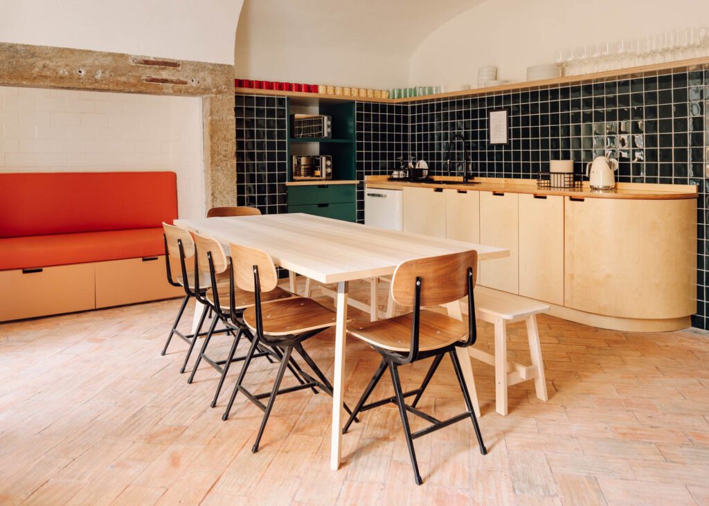 In the kitchen, Cantinho do Vintage chairs gather around an Ikea table and bench.