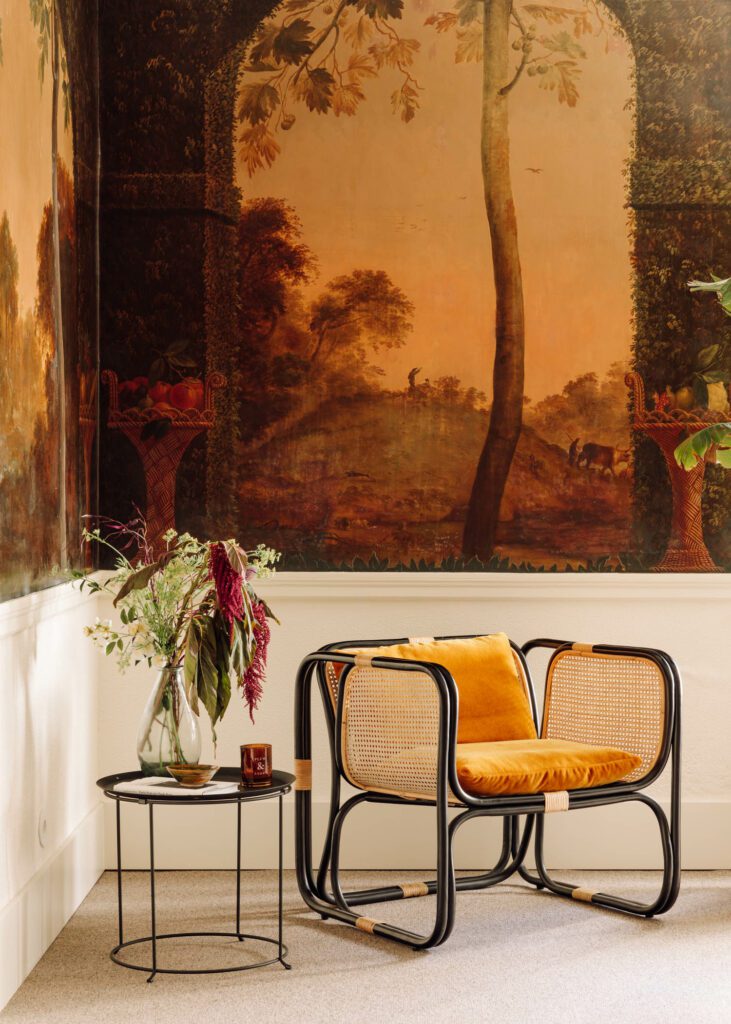 Rose Uniacke yellow velvet covers a rattan chair by Cantinho do Vintage in the fresco room.