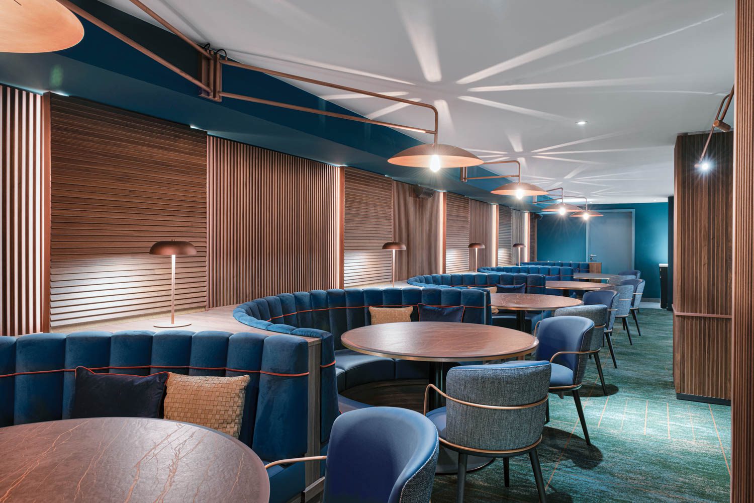 blue booths in the dining room of Pigeon Post Eatery & Bar