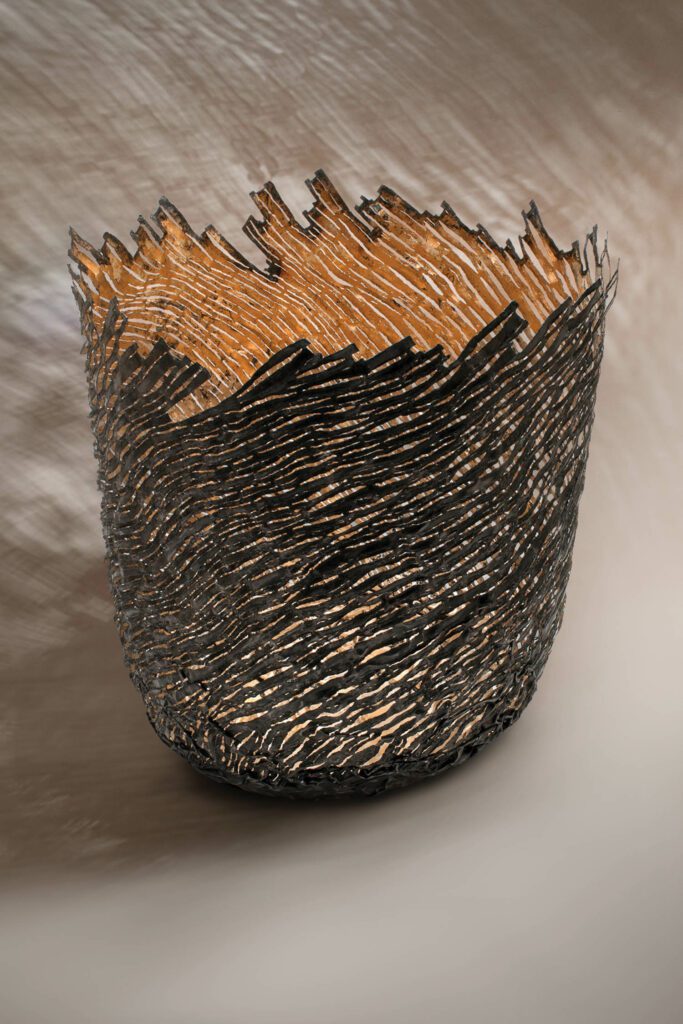 British metalsmith Claire Malet’s Marloes Strata Vessel, a tin can transformed by freehand flame cutting.