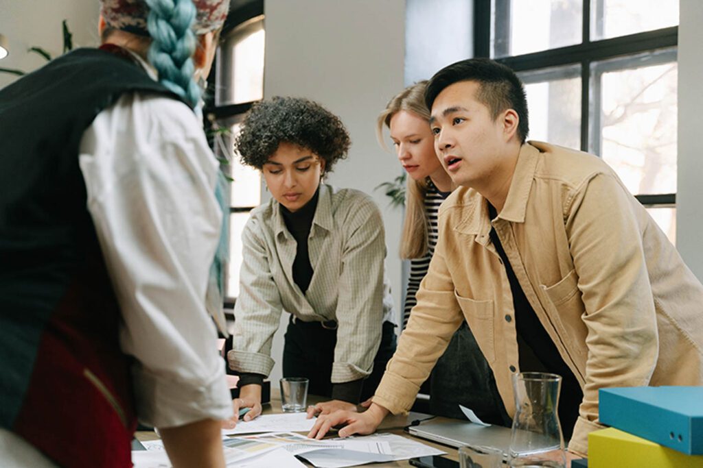 a group of designers works over a conference table