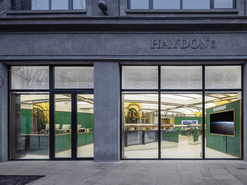 The neoclassical facade of the landmarked structure, formerly known as the Meilun Building, had to remain largely untouched. Opposite bottom: Materials traditionally associated with Shanghai’s past, like green leather and walnut, contrast with a contemporary light-box ceiling.