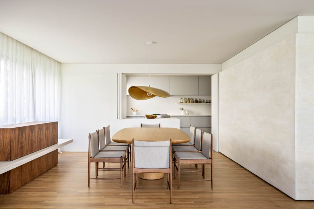 Linen curtains control light in the dining room, where the custom table is by Estudio Rain.