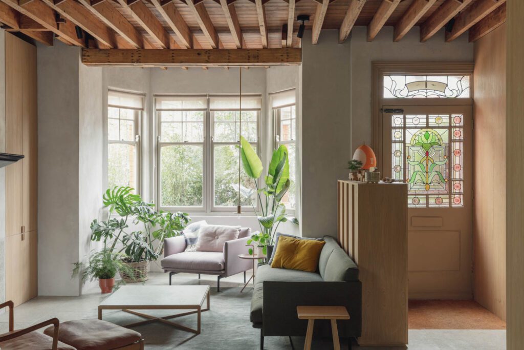 A Rachel Kemp stained glass window colors the living area’s Muuto sofa and arm chair, Carl Hansen lounge chair, Hay side tables, and Knoll coffee table with a custom Grassi Pietre top.