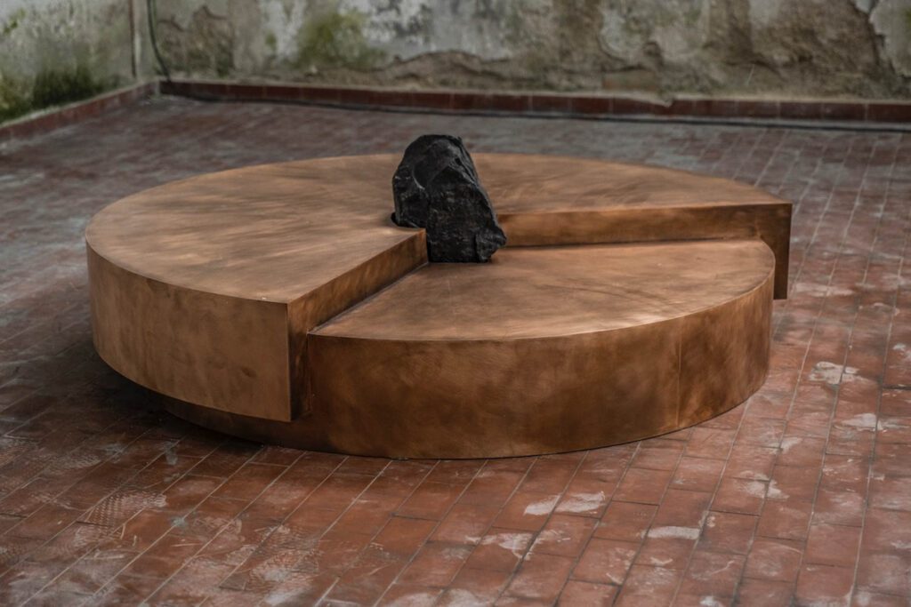 Tapping a childhood passion for archeology, Pierre De Valck placed a rare, nearly veinless black Belgian stone in the center of his solid bronze and found stone Timetable coffee table. 