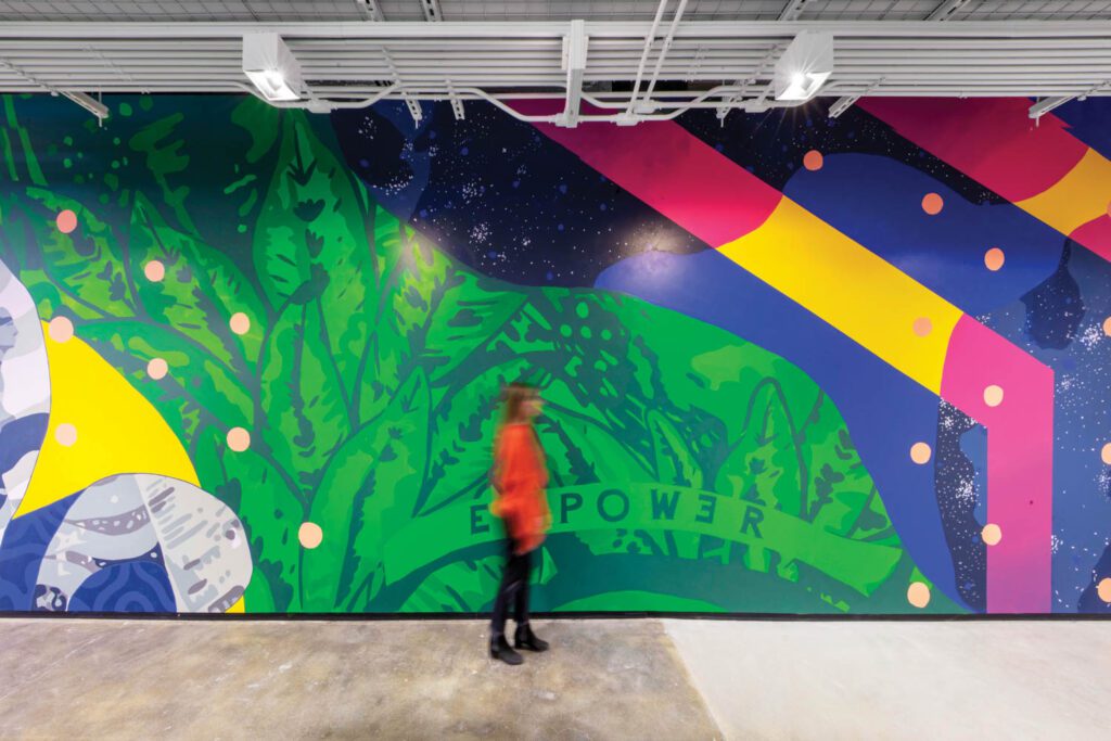 A mural by local Black experiential designer Jayvn Solomon energizes a fourth-floor corridor, where polished-concrete flooring is original, as it is throughout.