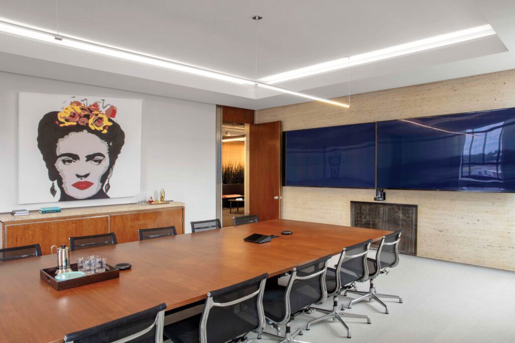 The travertine wall, fireplace, and credenza are all original to this conference room, once part of the office suite of Joseph Pulitzer, founder of the St. Louis Post-Dispatch, which had occupied the building.