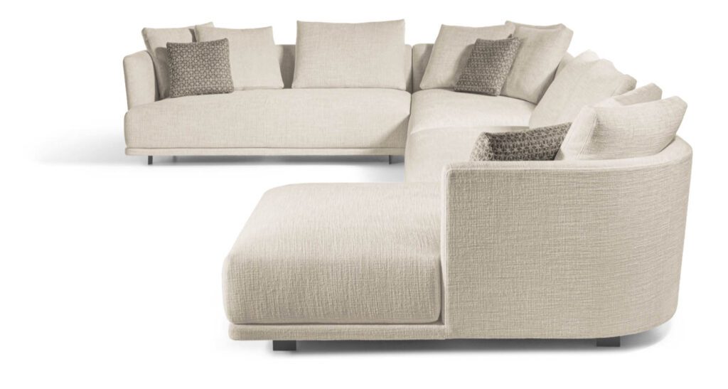 The curvilinear shell of this modular sectional with loose pillows looks good from all angles—place it in the center of a room for maximum impact. 