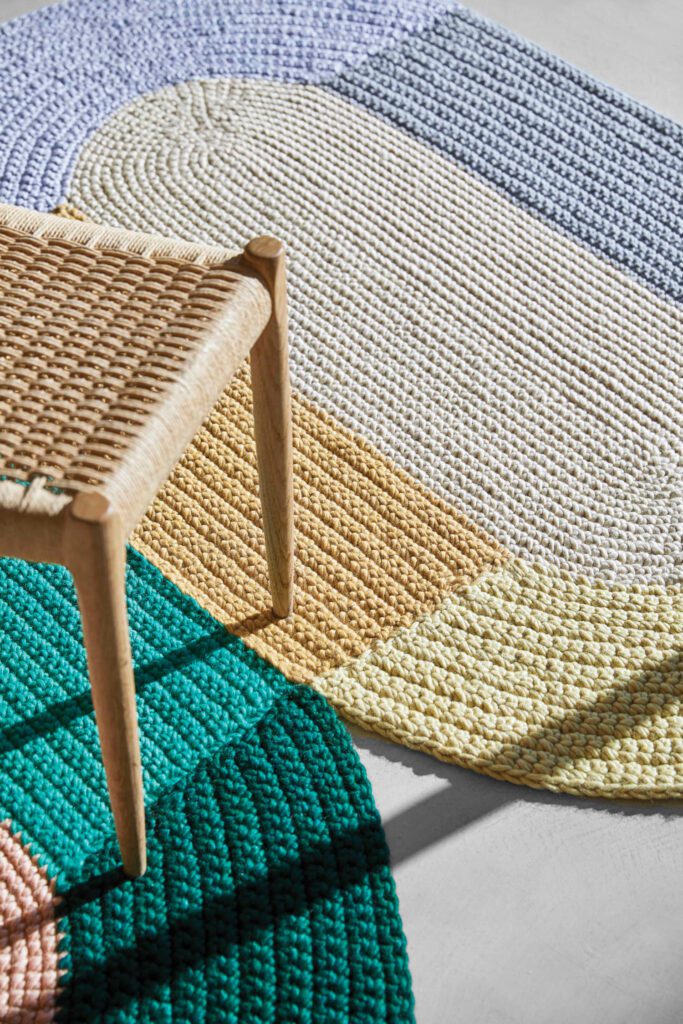 Cheery color blocks by the Swedish designer pattern oval rugs stitched together into a long runner, pushing the boundaries of what’s possible with crocheted wool fibers.