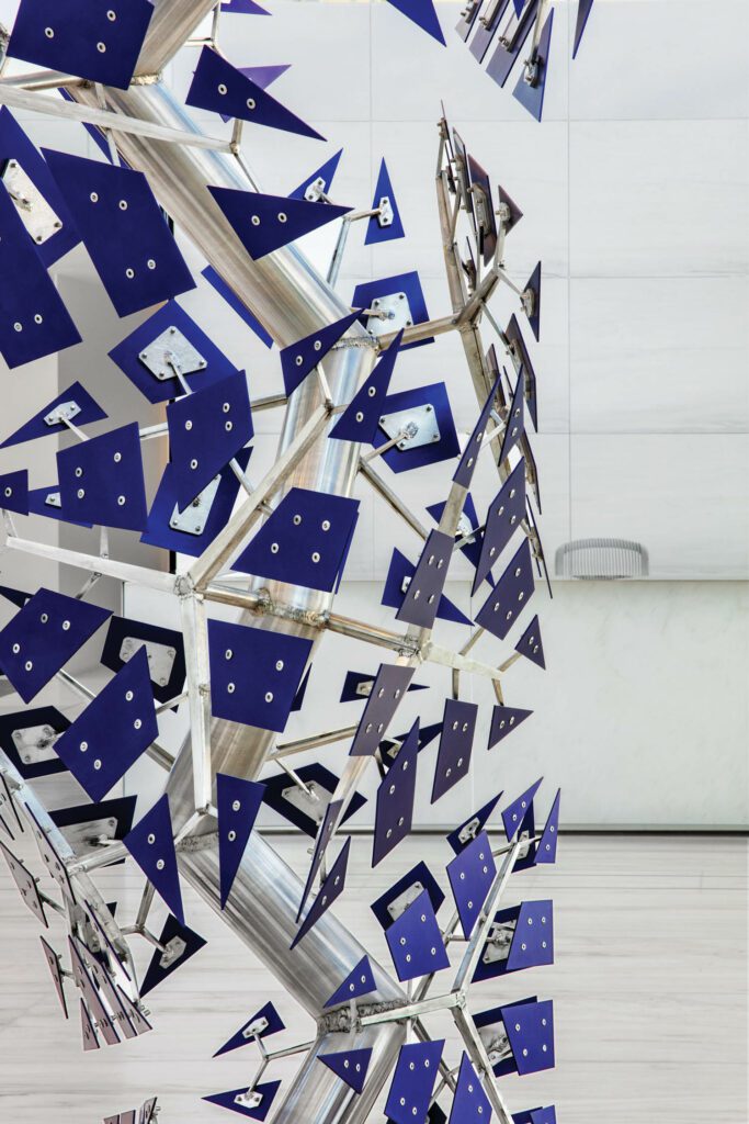 Titled Fractured Paradigm (blue), the Shawcross sculpture is com­posed of hundreds of anodized-aluminum tetrahedrons.