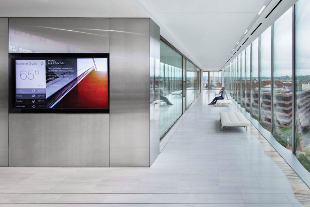 Conference and collaboration zones flank the elevator lobby, paneled in brushed stainless steel, and afford far-reaching north and west views.