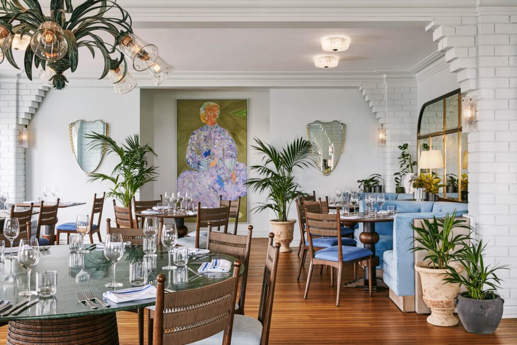 Dinah’s Restaurant features one of many paintings by artist-in-residence Jai Vasicek, along with fresh flowers, green and blue tonal hues and bespoke lighting by Bruce Pryor, a local ceramicist. 