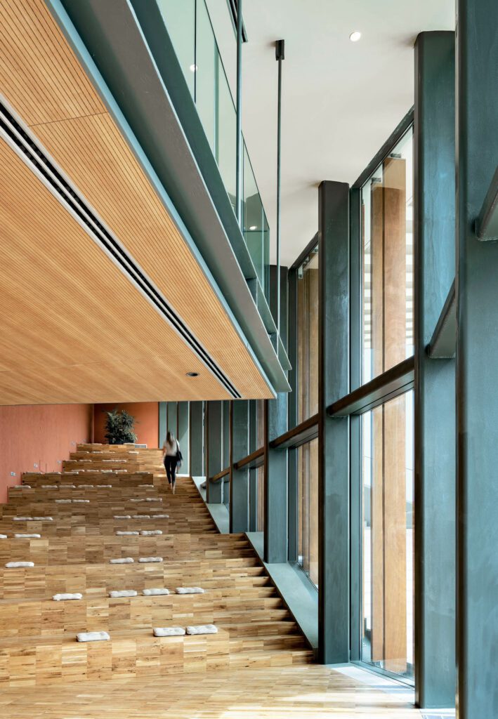 A café with bleacher seating at the Palazzo Senza Tempo, a multiuse complex of new construction and repurposed houses in Peccioli. Photography by Duccio Malagamba.