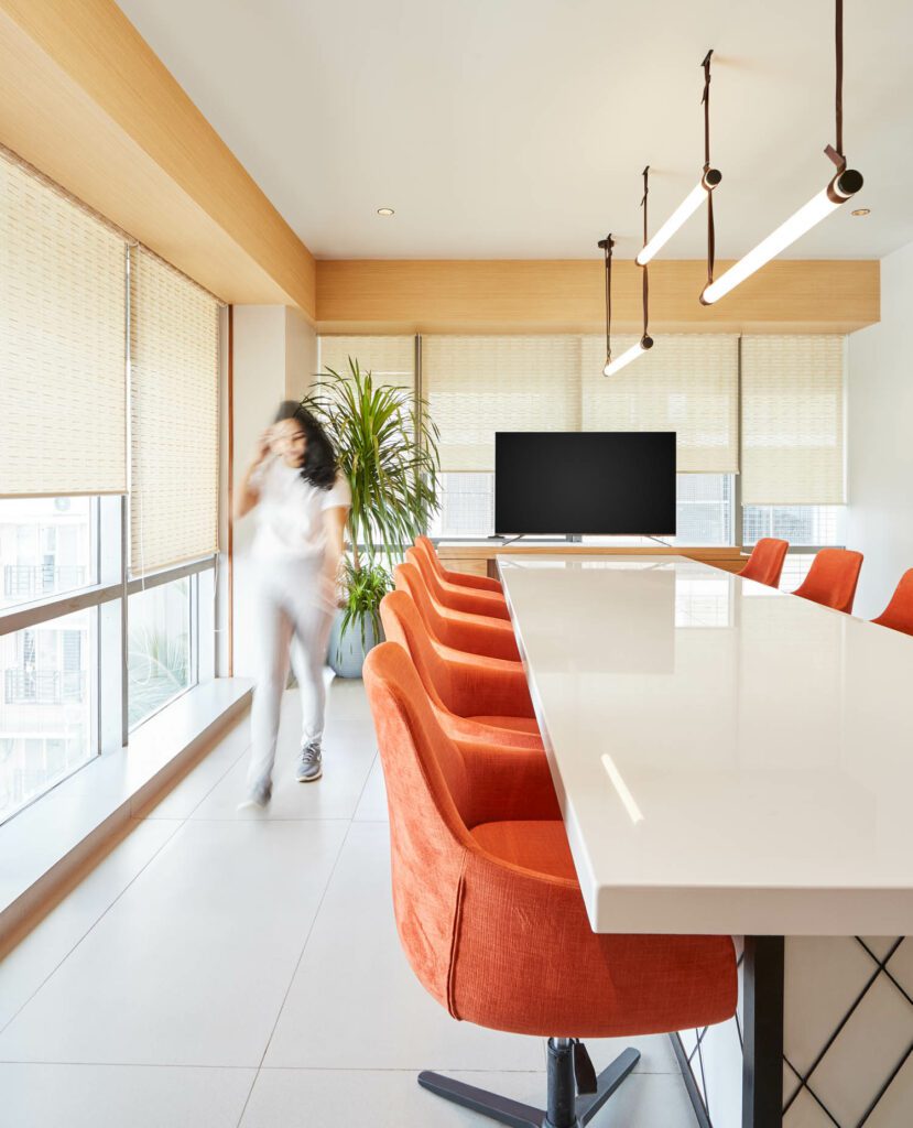 Natural light floods the office, including the conference room.