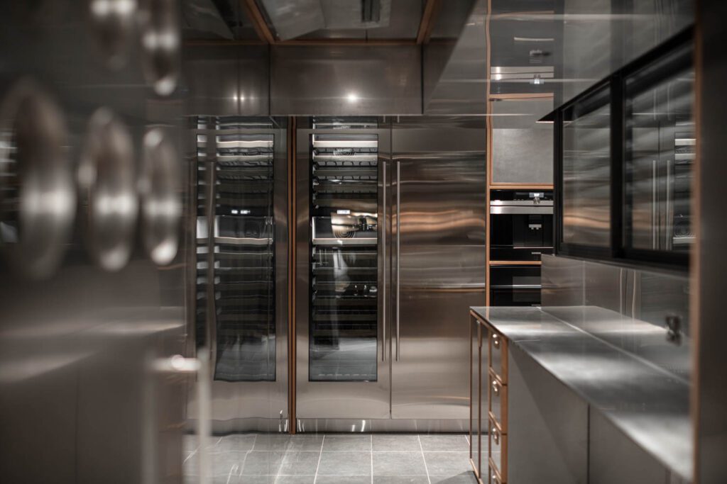 Highly reflective stainless steel defines the kitchen.